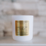 Candle with a gold label on a white surface
