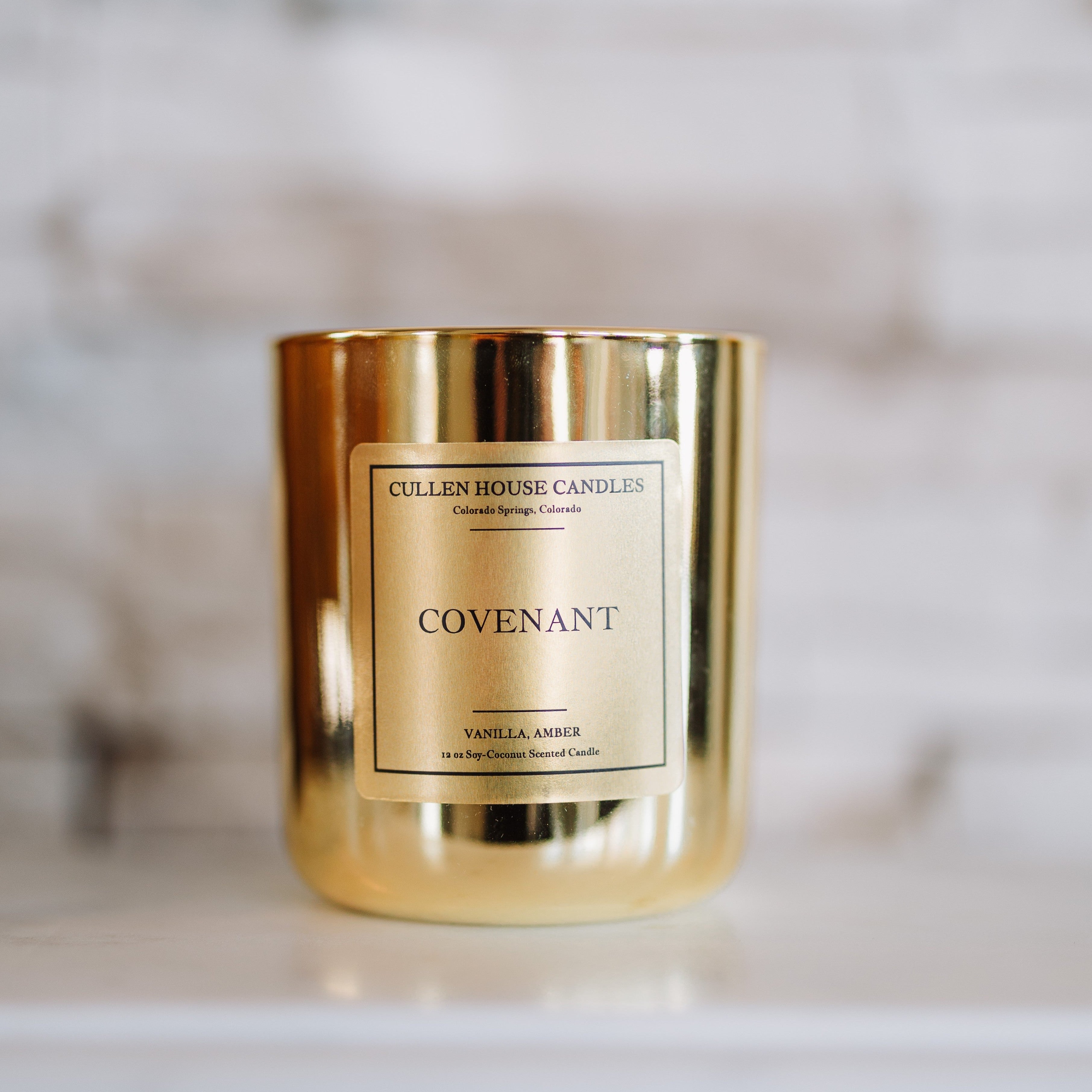 Gold candle with 'Cullen House Candles' label on a marble surface