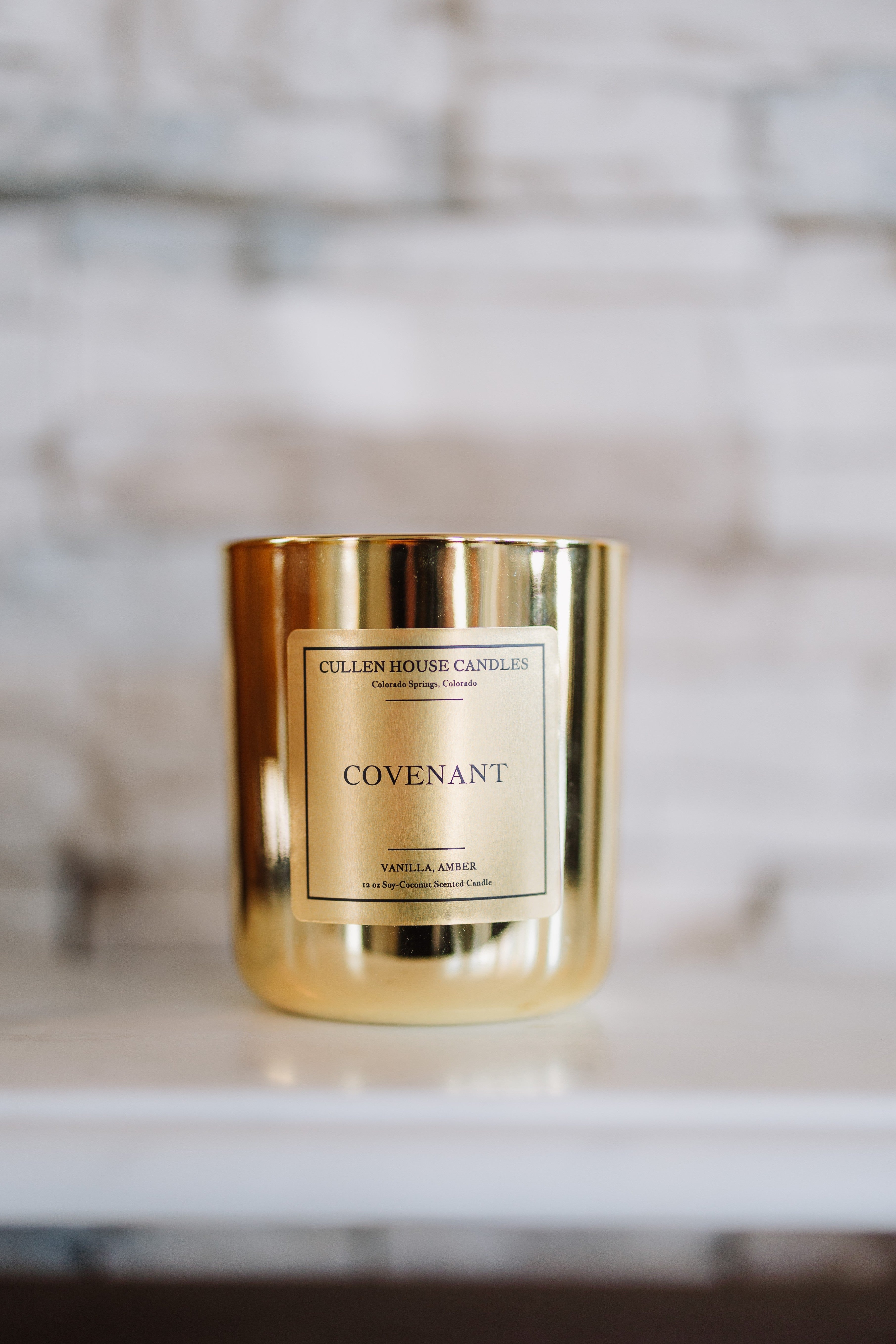 Gold candle with 'Cullen House Candles' label on a marble surface