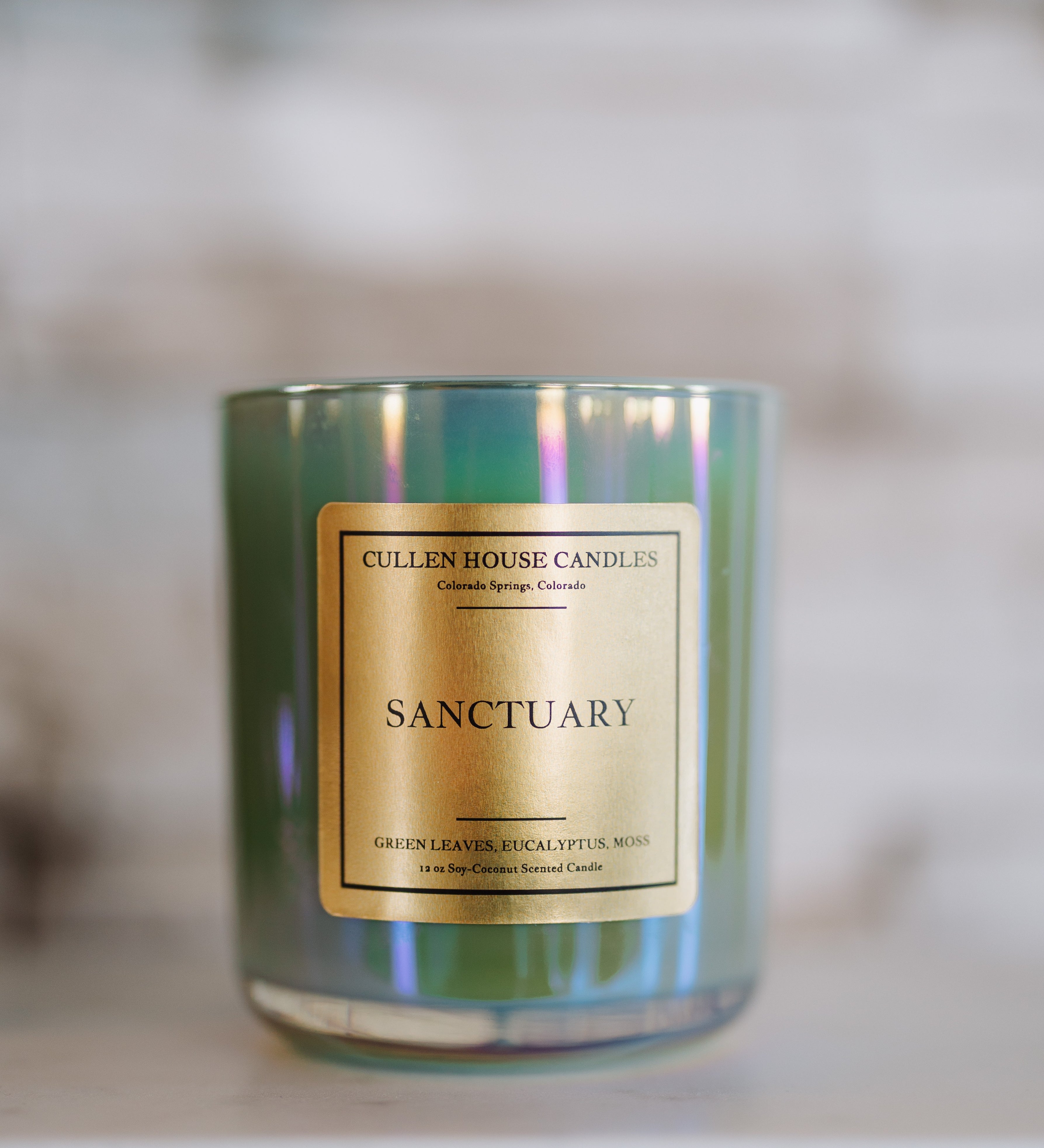 Candle with a gold label on a blurred background
