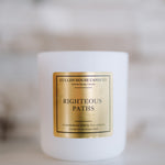 Candle with a gold label on a blurred background
