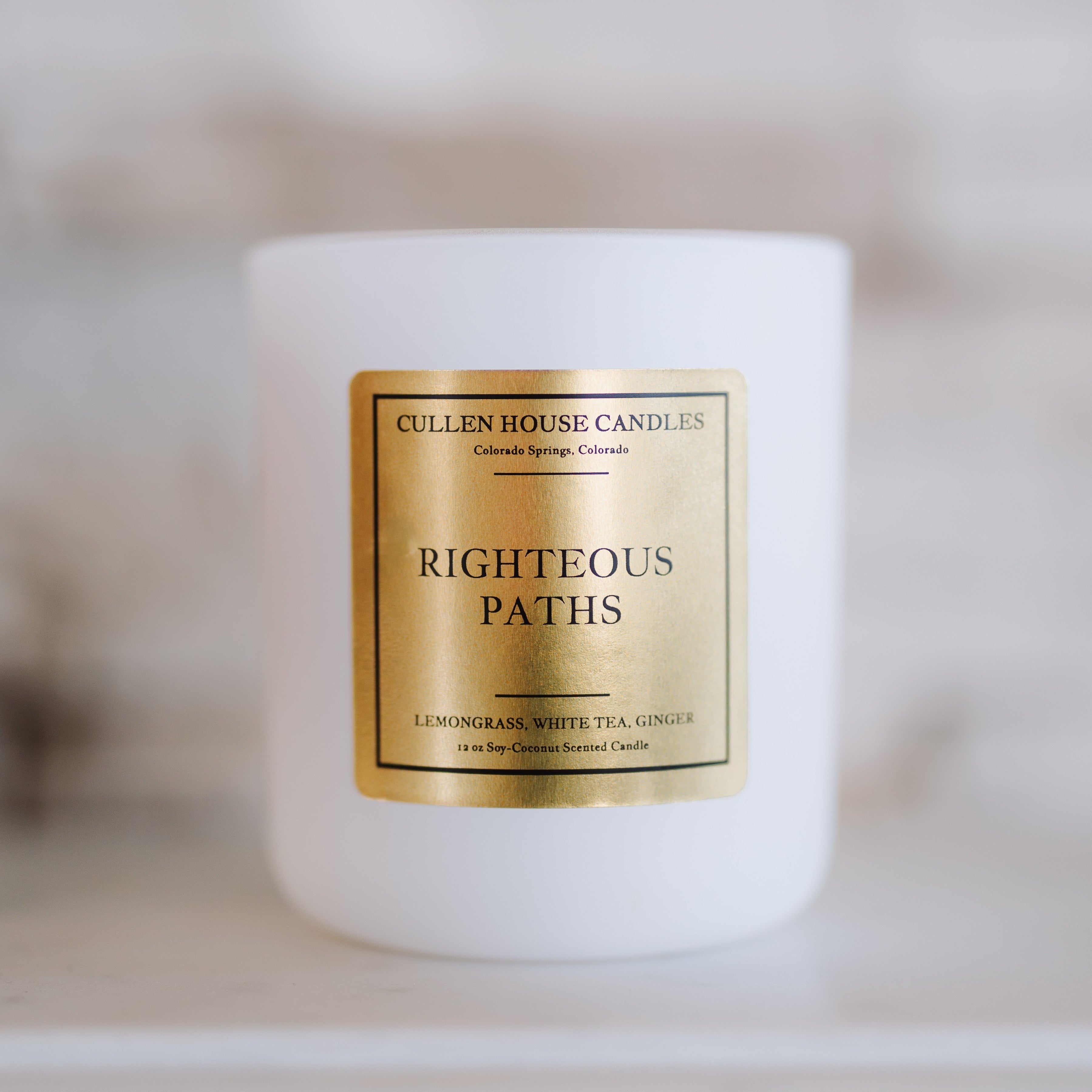 Candle with a gold label on a blurred background
