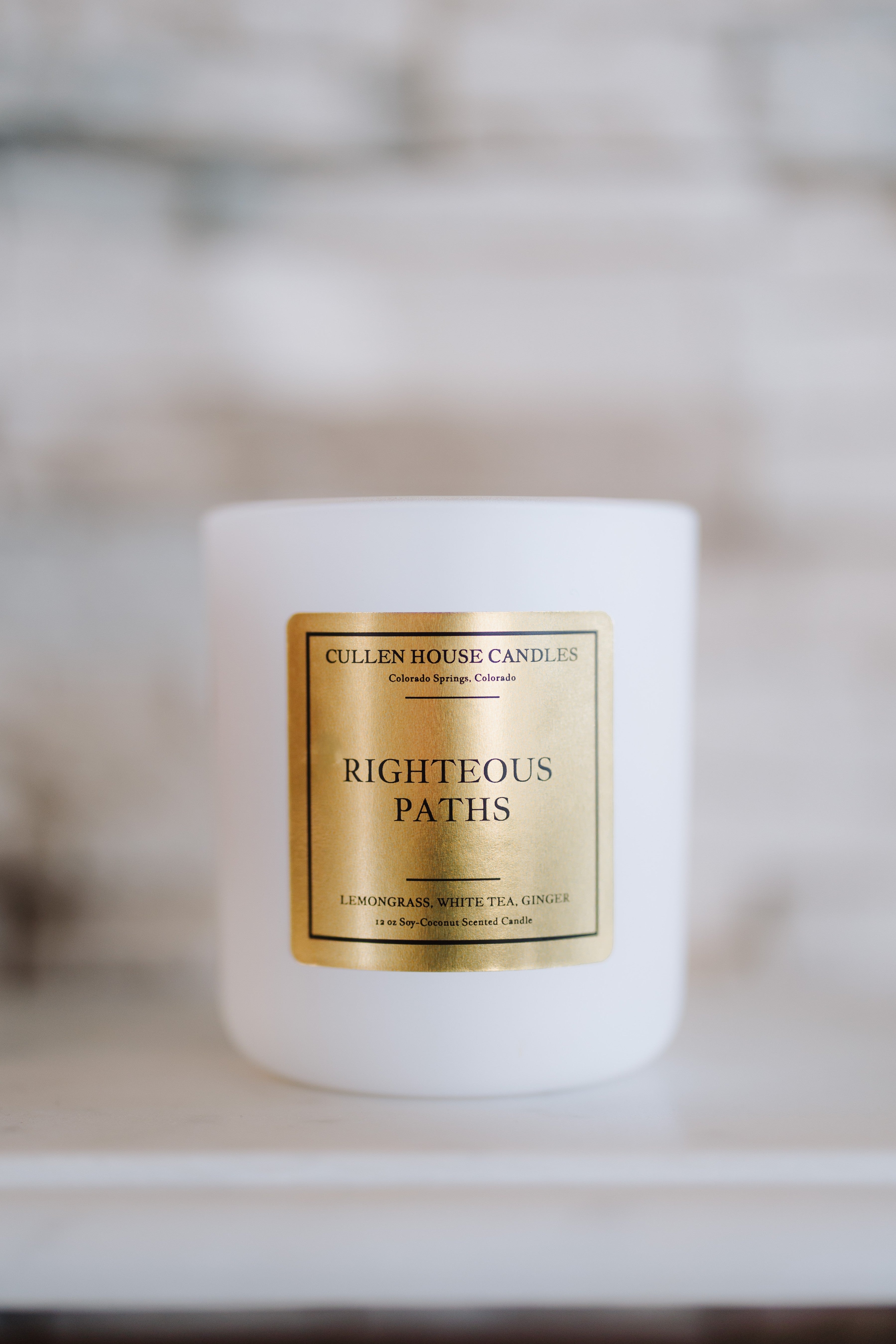 Candle with a gold label on a blurred background
