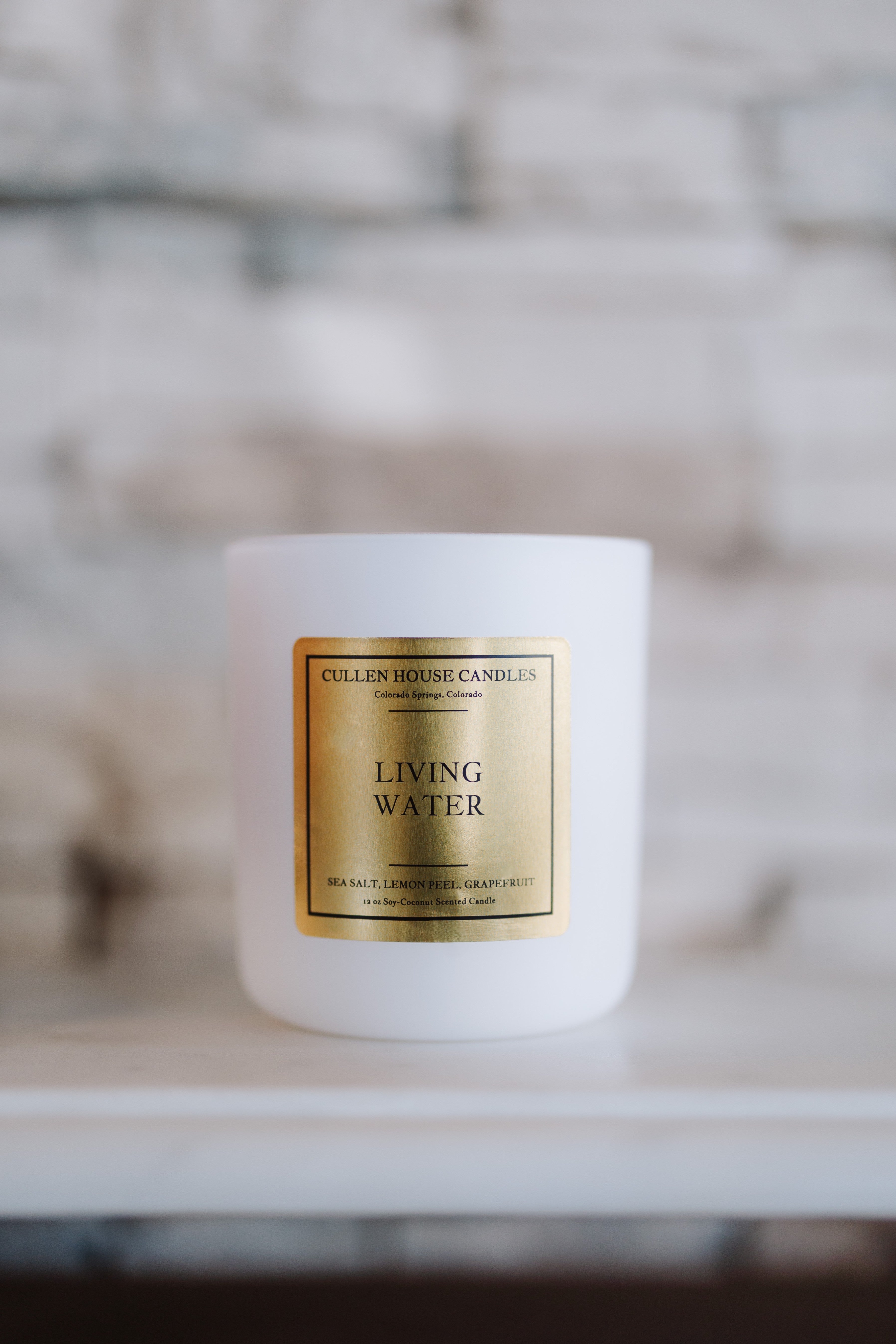 Candle labeled 'Living Water' by Cullen House Candles on a neutral background