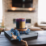 Candle with decorative elements on a table in a living room setting