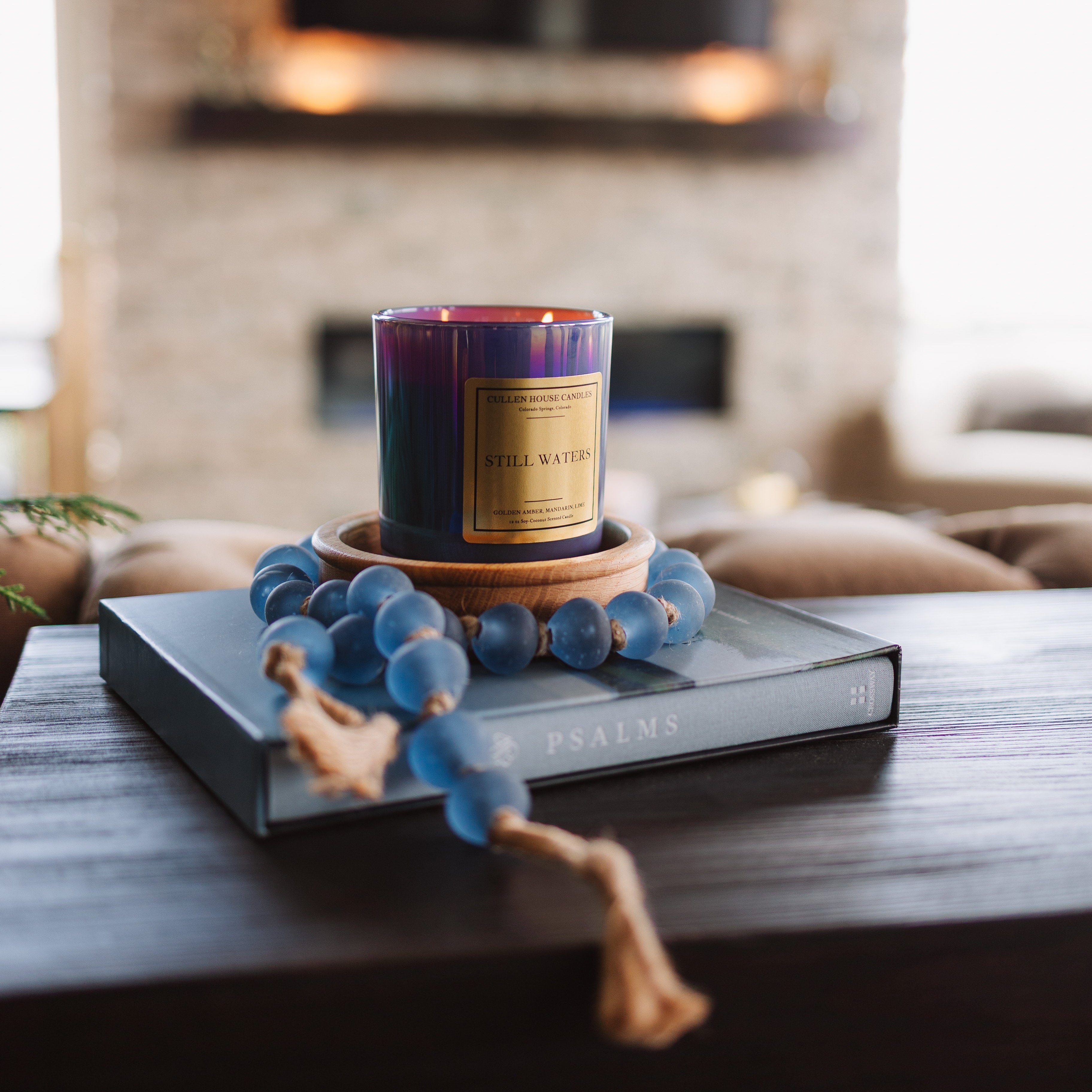 Candle with decorative elements on a table in a living room setting