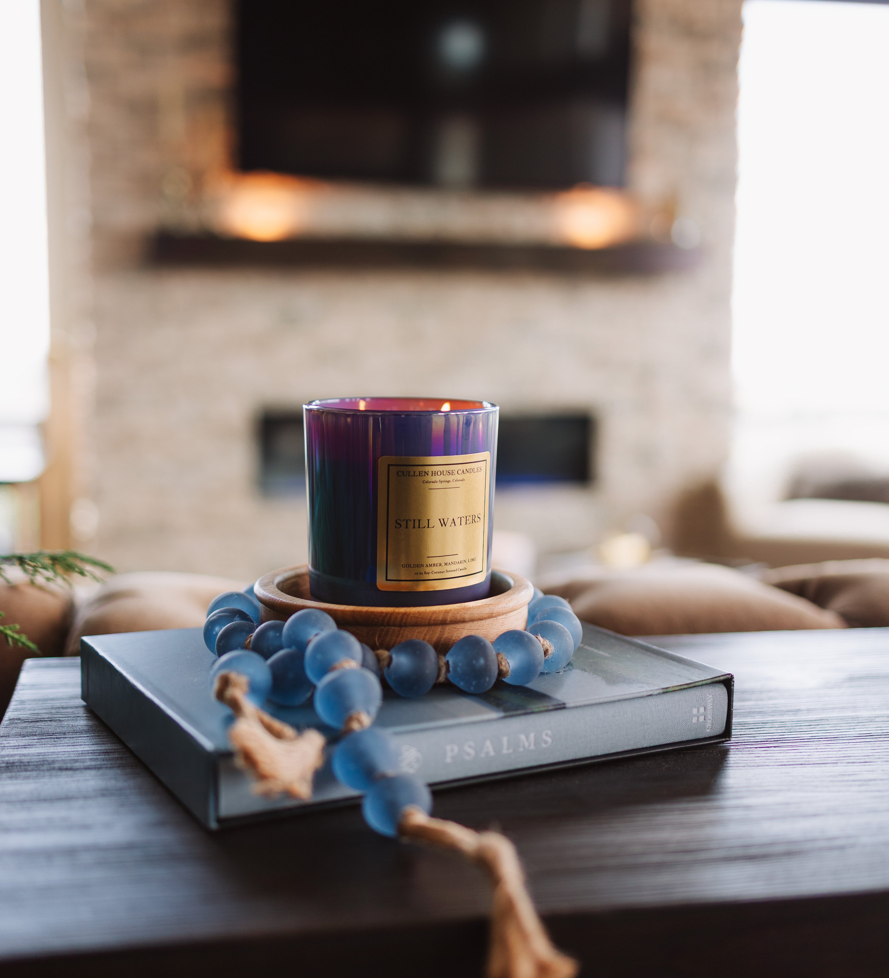 Candle with decorative elements on a table in a living room setting