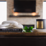 Candle and books on a wooden surface with a blurred background