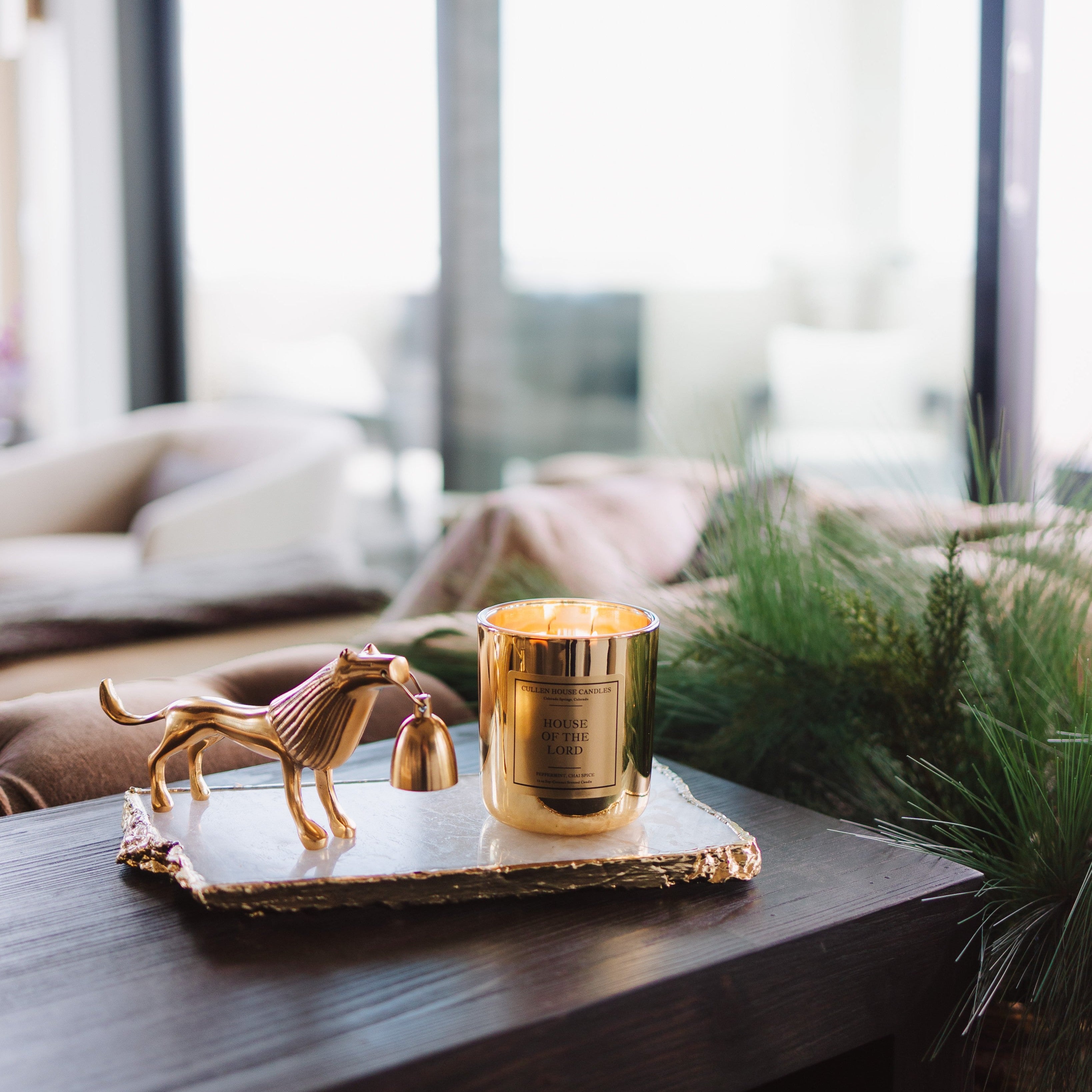Gold candle on a table with decorative elements in a home setting