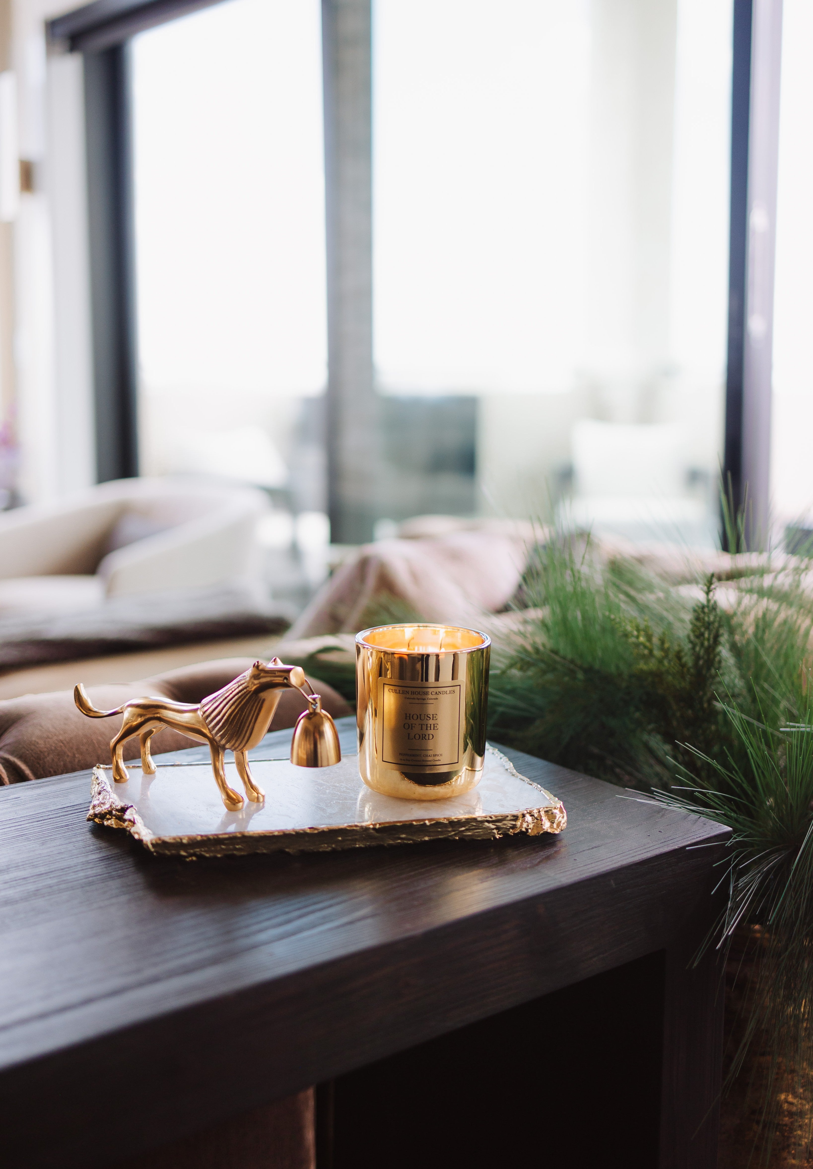 Gold candle on a table with decorative elements in a home setting