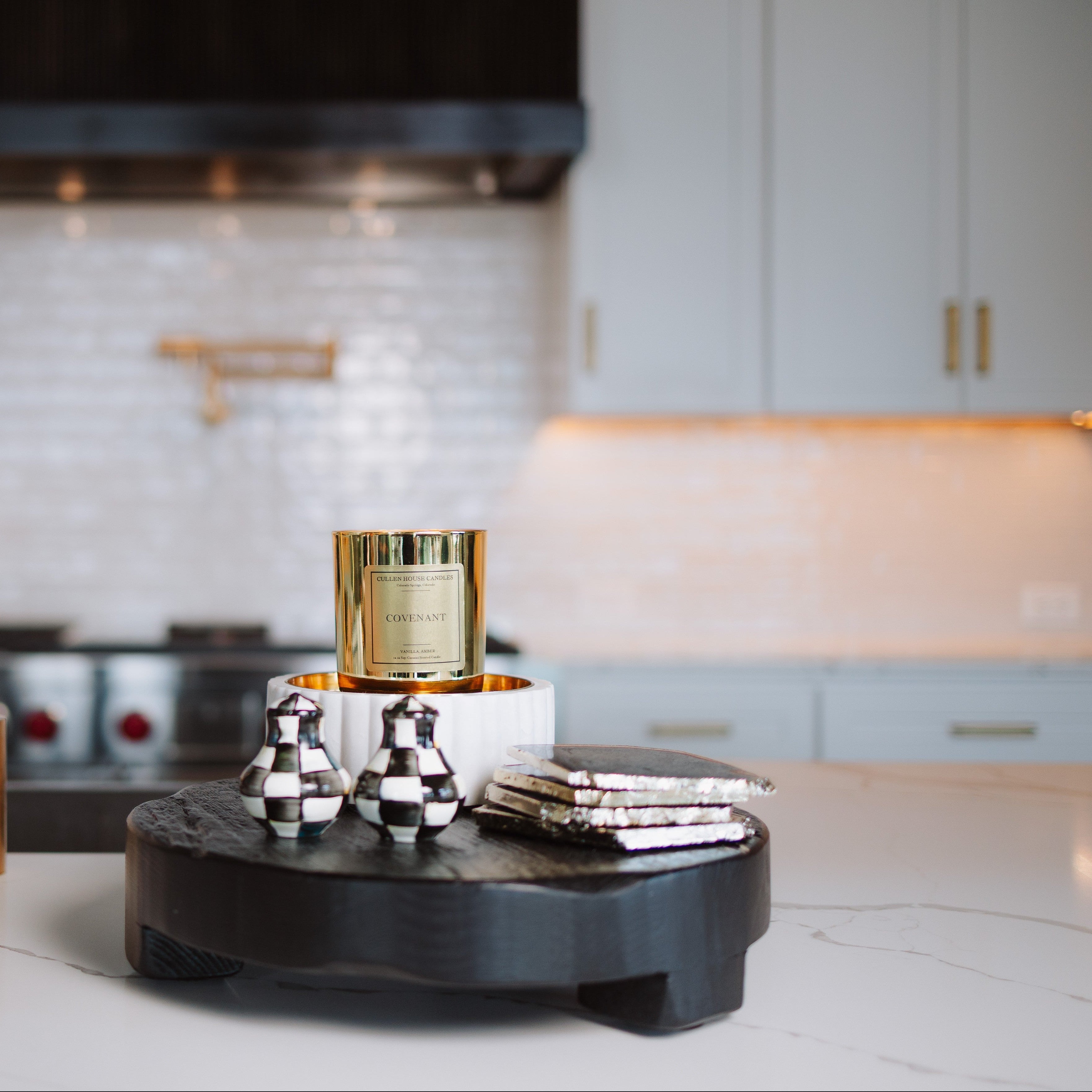 Decorative items on a black round stand in a kitchen setting