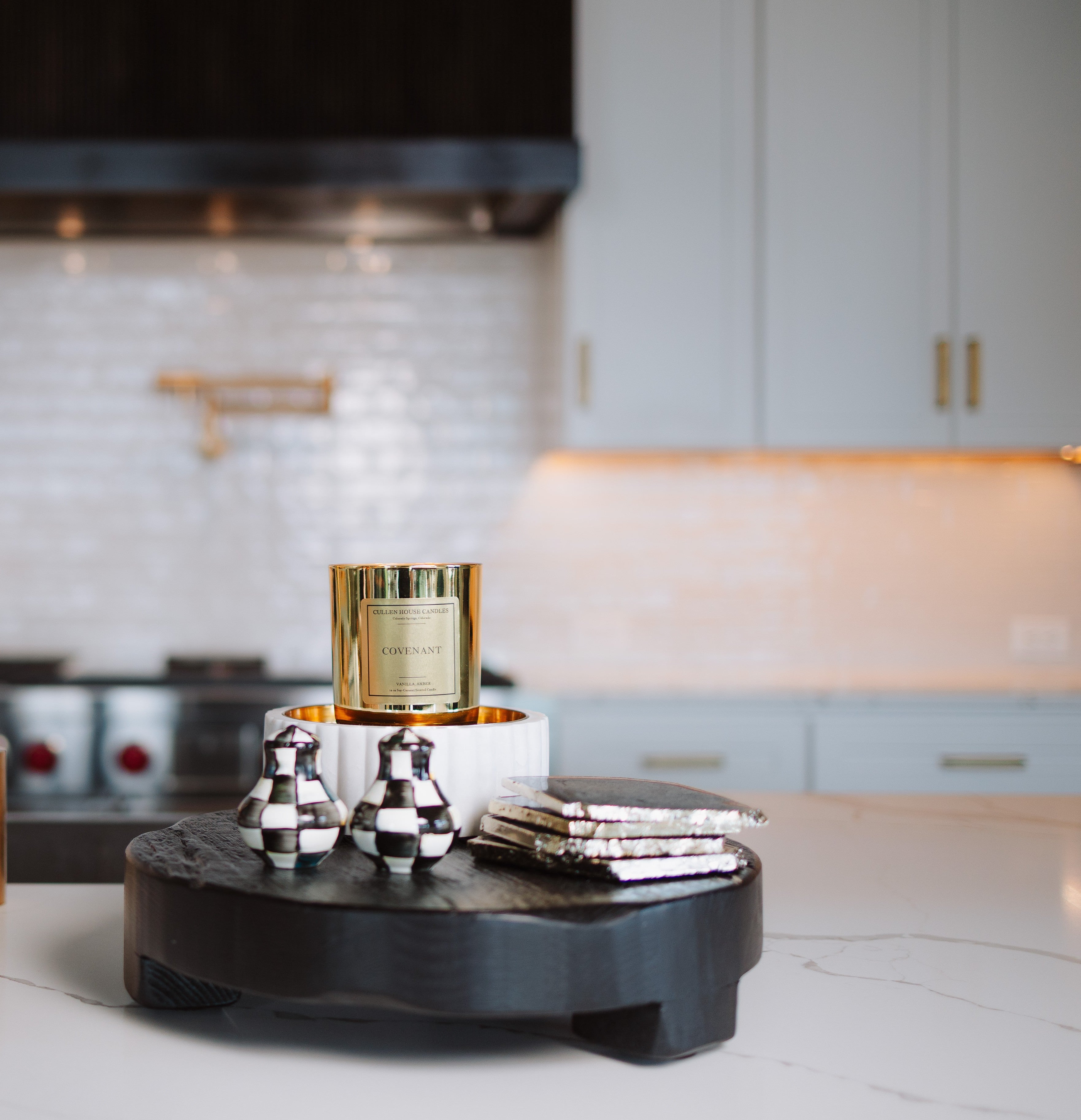 Decorative items on a black round stand in a kitchen setting