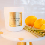 Candle labeled 'Righteous Paths' with lemons on a white surface