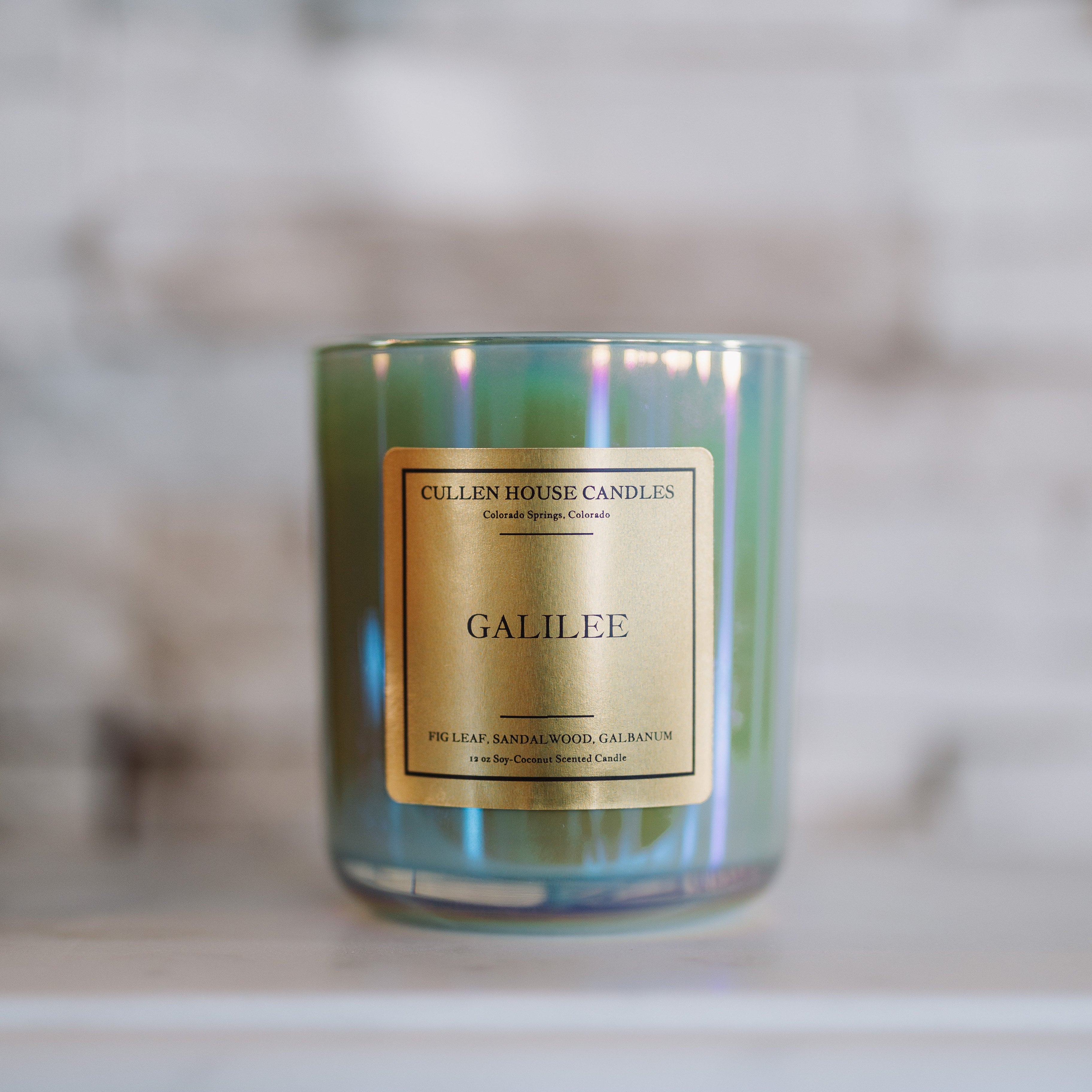 Candle labeled 'Galilee' by Cullen House Candles on a marble surface with a blurred background.