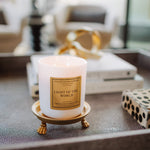 Candle labeled 'Light of the World' on a decorative stand in an indoor setting