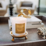 Candle labeled 'Light of the World' on a decorative stand in an indoor setting