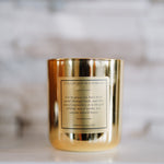 Gold candle with a label on a blurred background