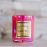Pink candle with a label on a blurred background