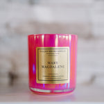 Candle with 'Mary Magdalene' label on a blurred background