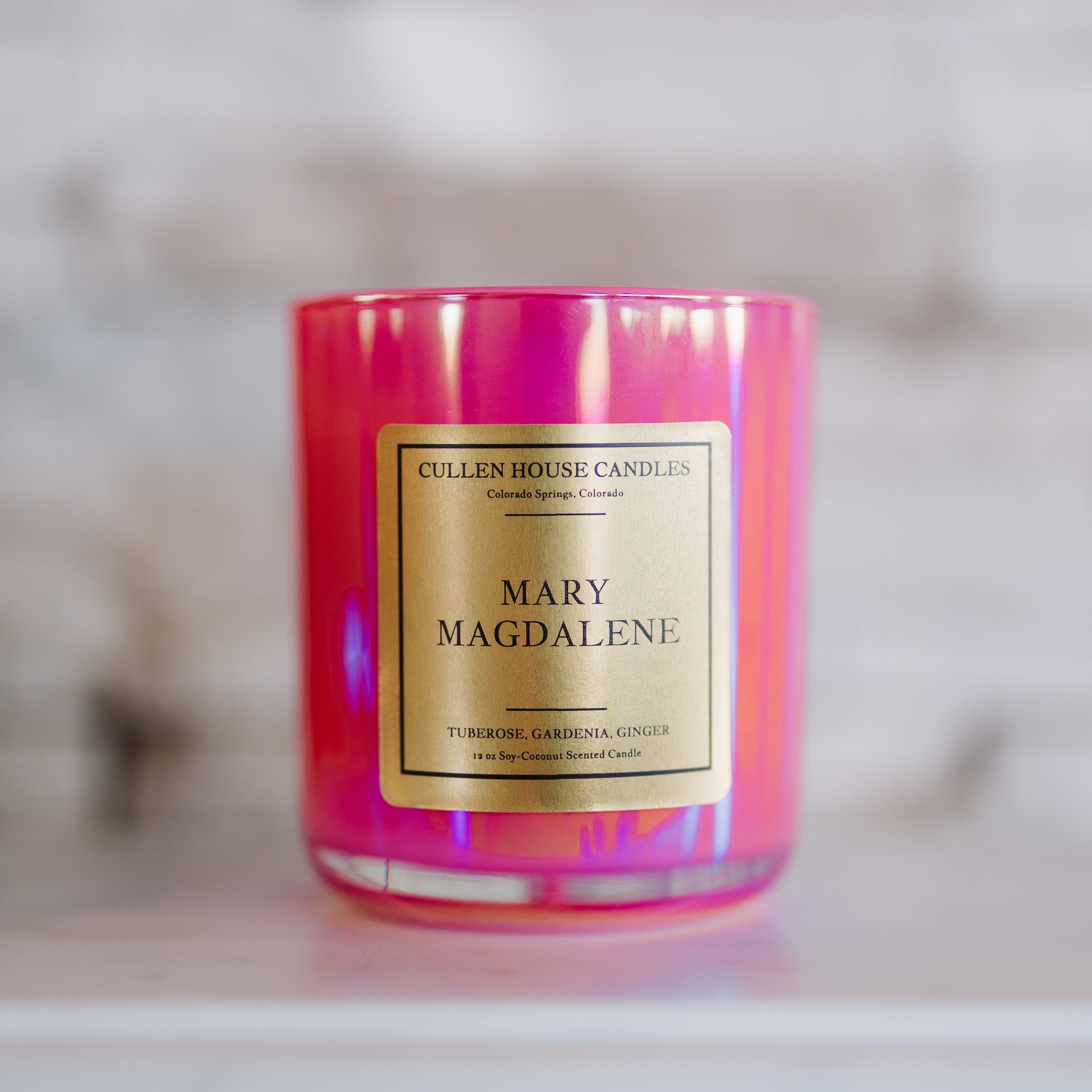 Candle with 'Mary Magdalene' label on a blurred background