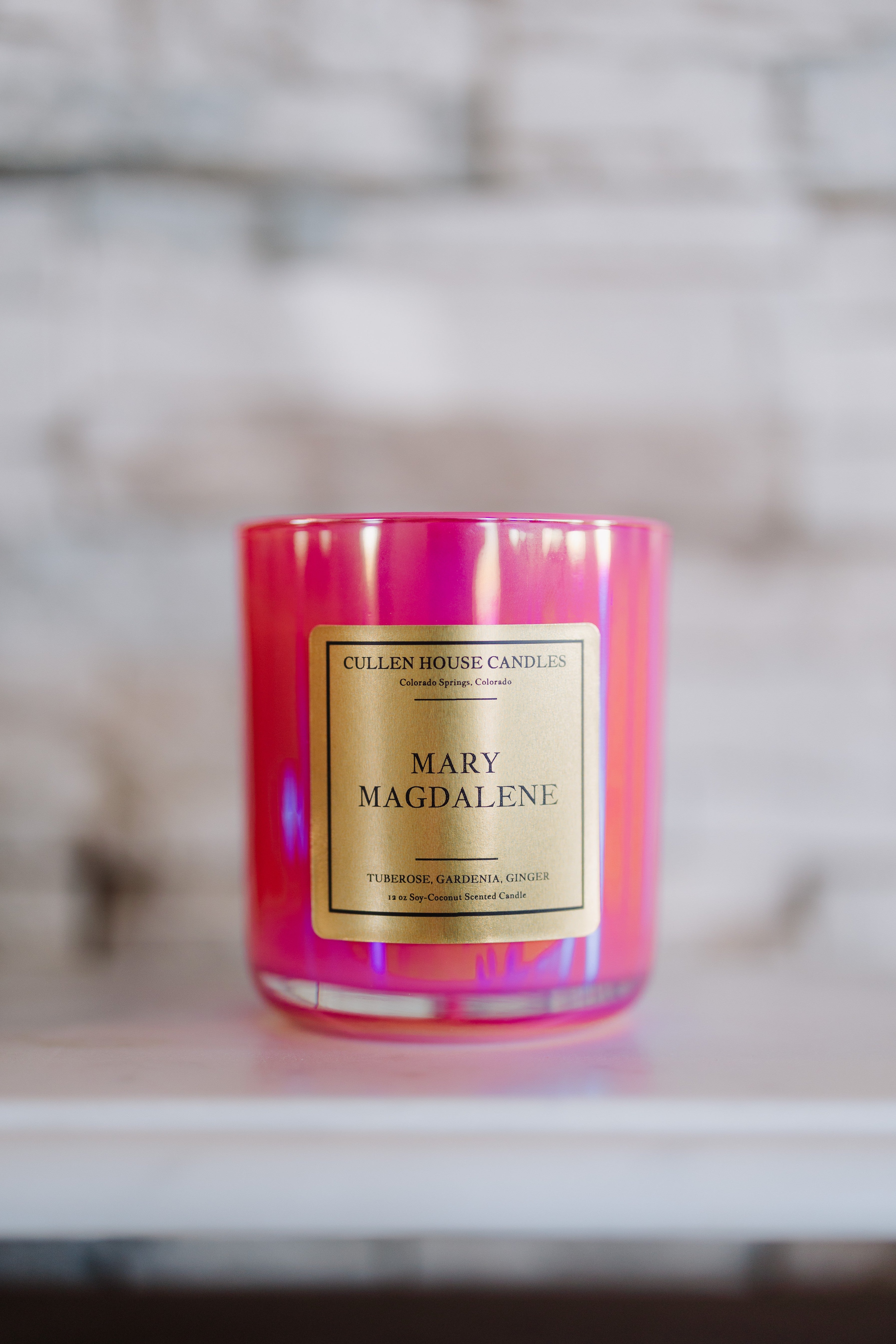 Candle with 'Mary Magdalene' label on a blurred background