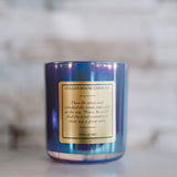 Blue candle with a gold label on a marble surface