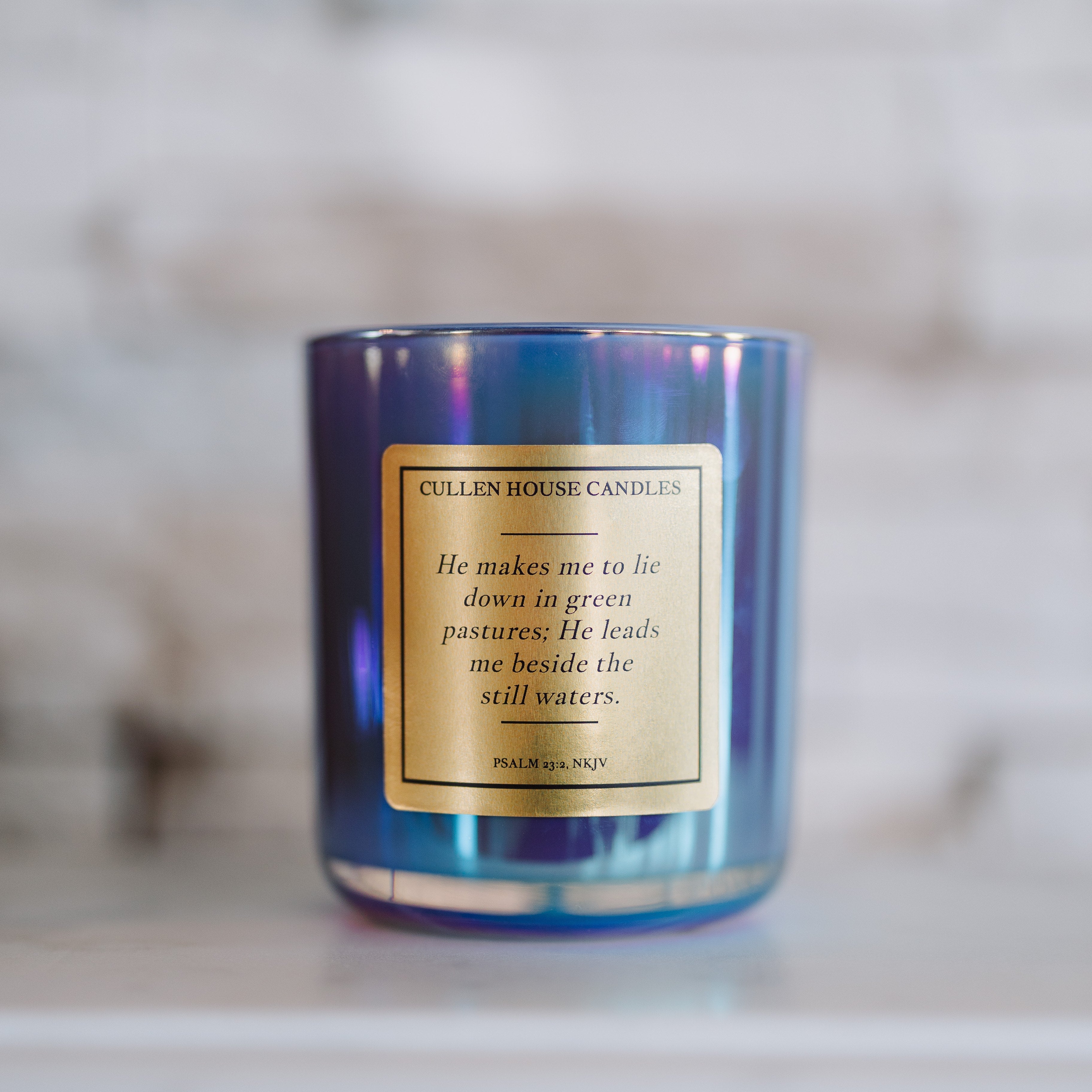 Candle with a label on a marble surface