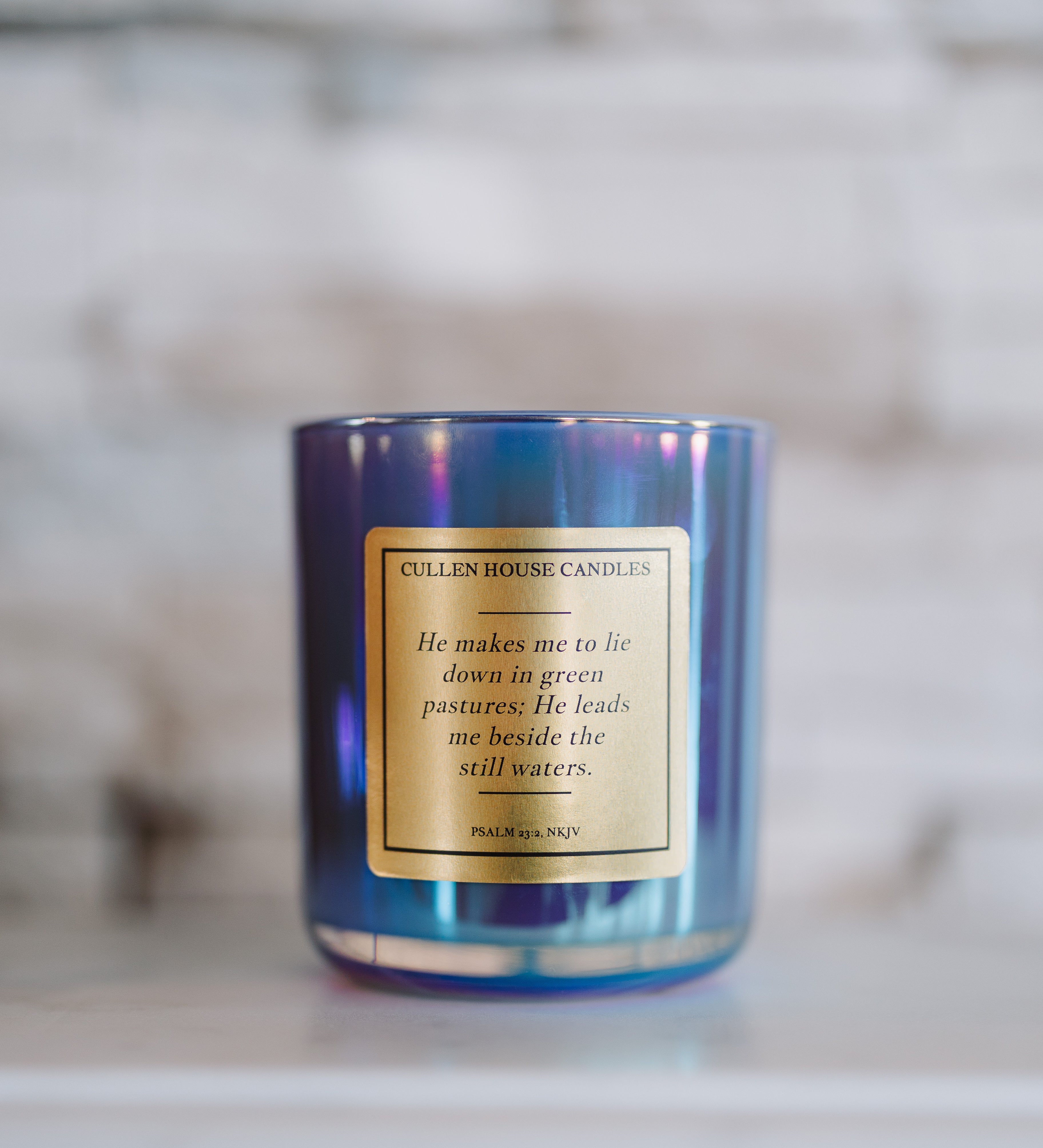 Candle with a label on a marble surface