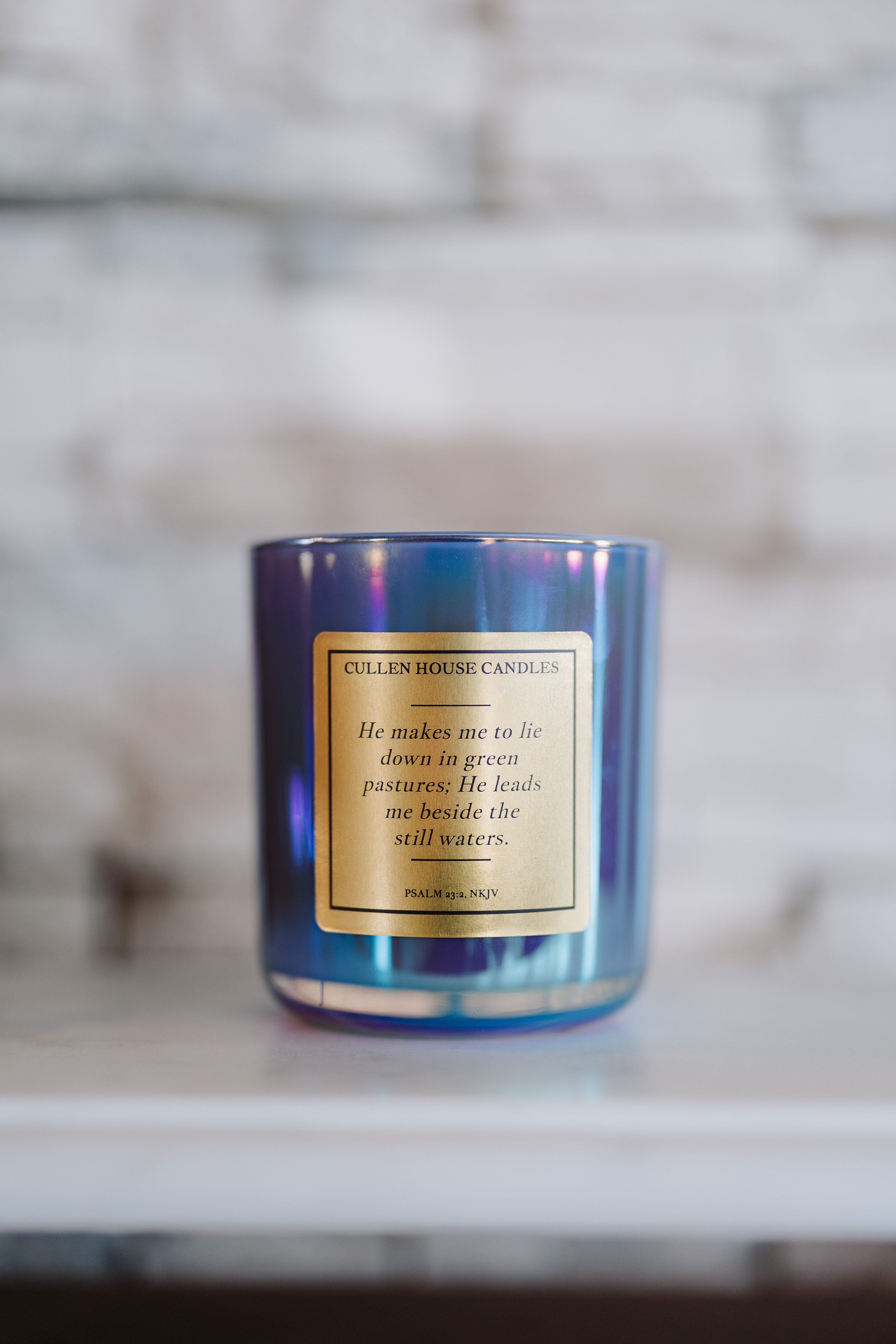 Candle with a label on a marble surface