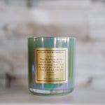 Candle with a gold label on a blurred background