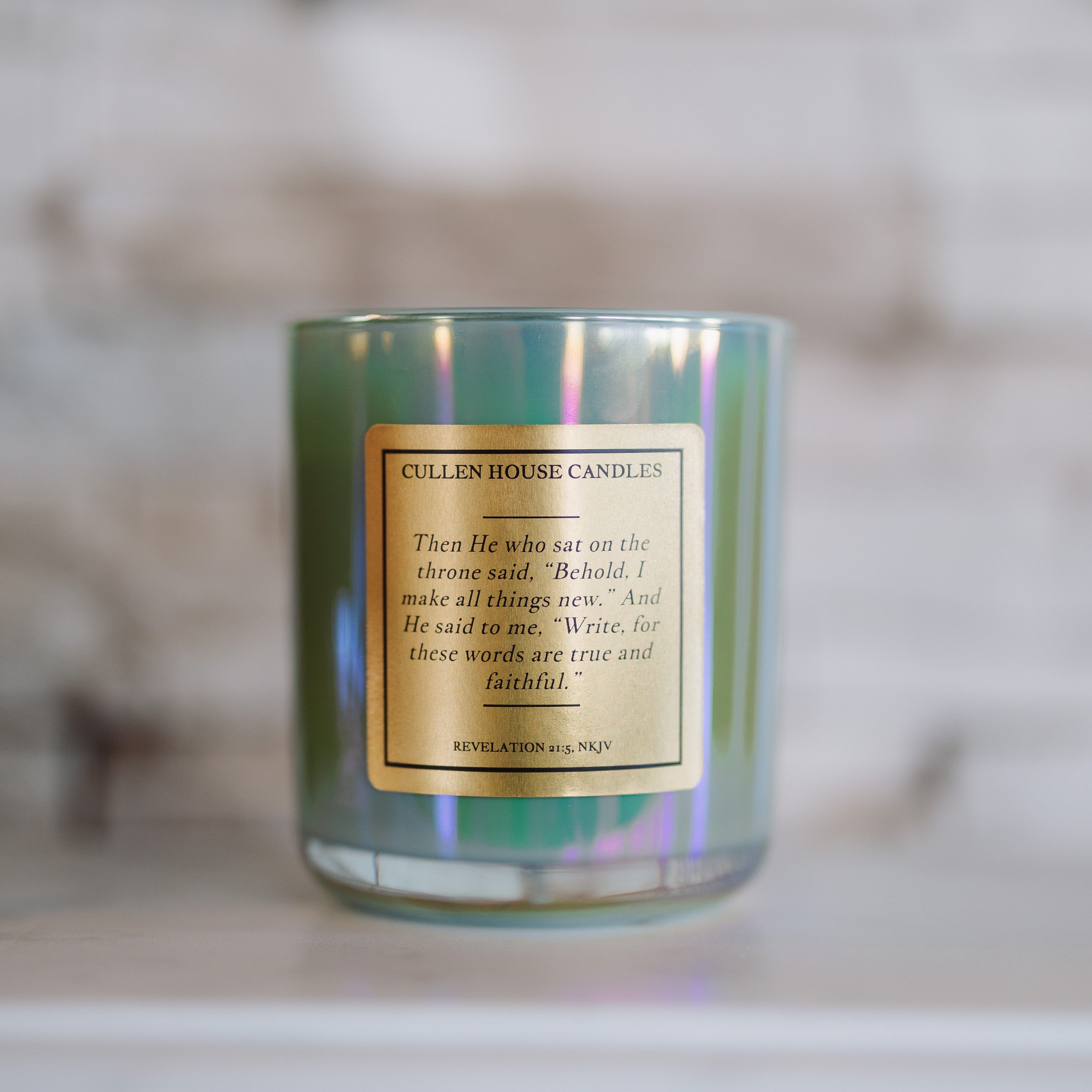 Candle with a gold label on a blurred background