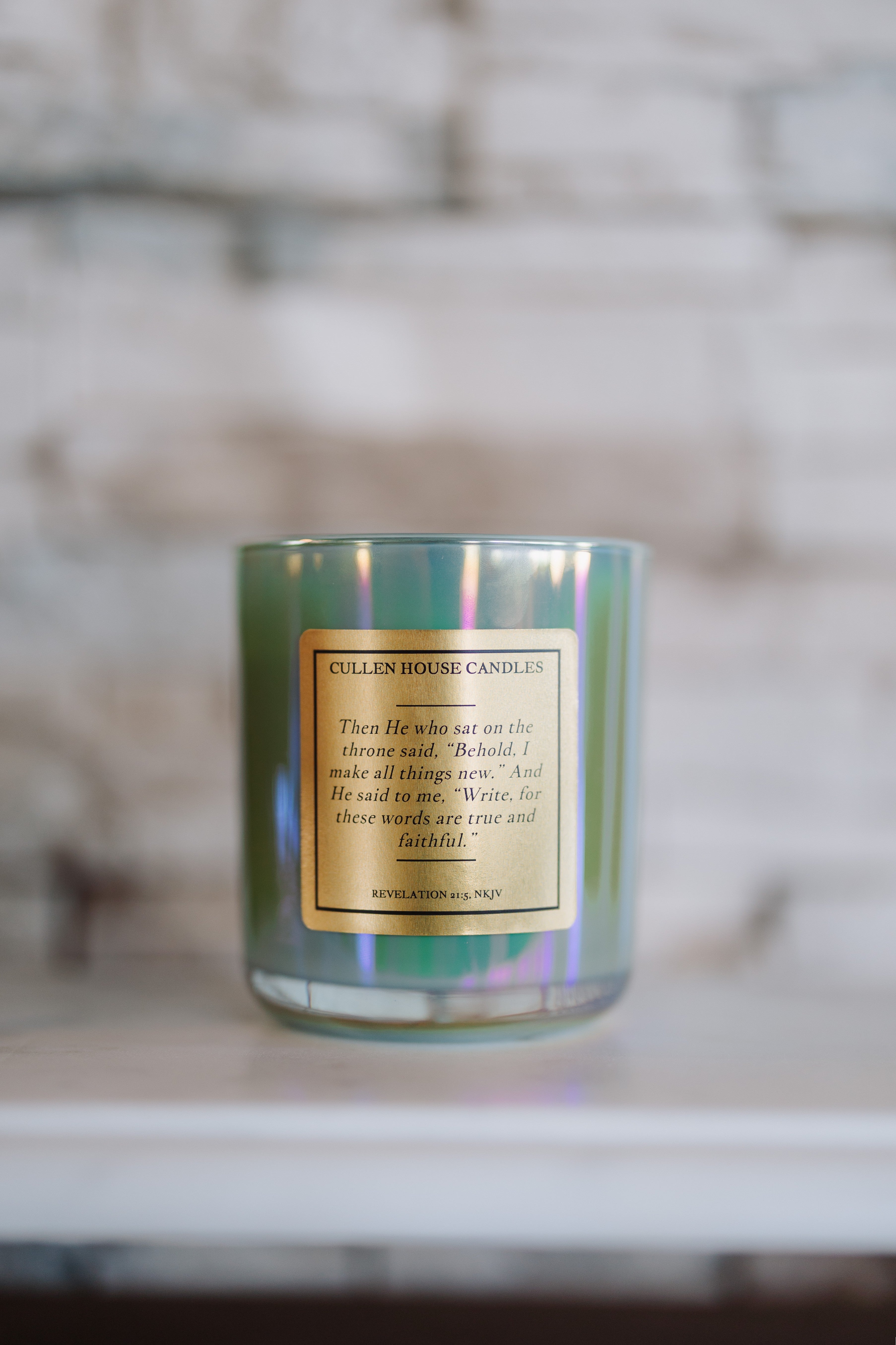Candle with a gold label on a blurred background